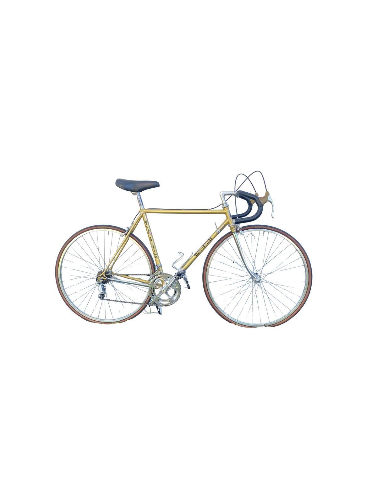 A vintage road bicycle with a gold frame, black saddle and handlebar tape, and thin tires, shown against a plain white background.
