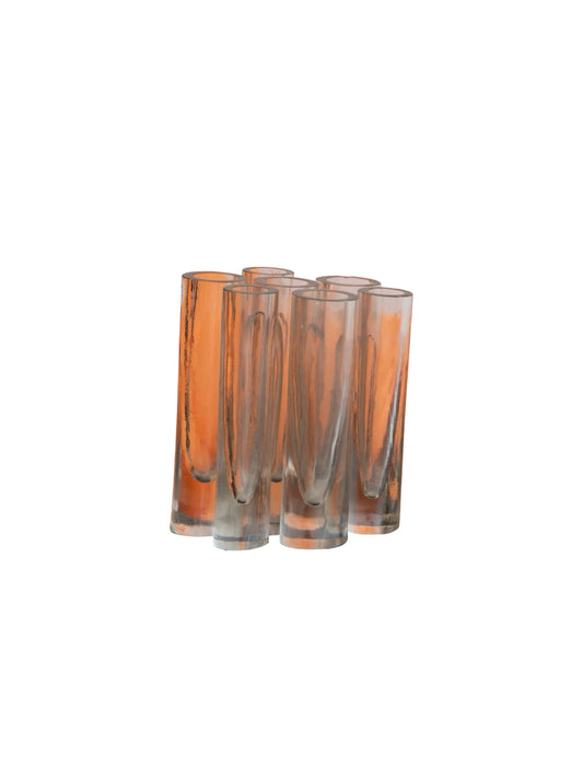 Set of four amber glass tumblers on a white background