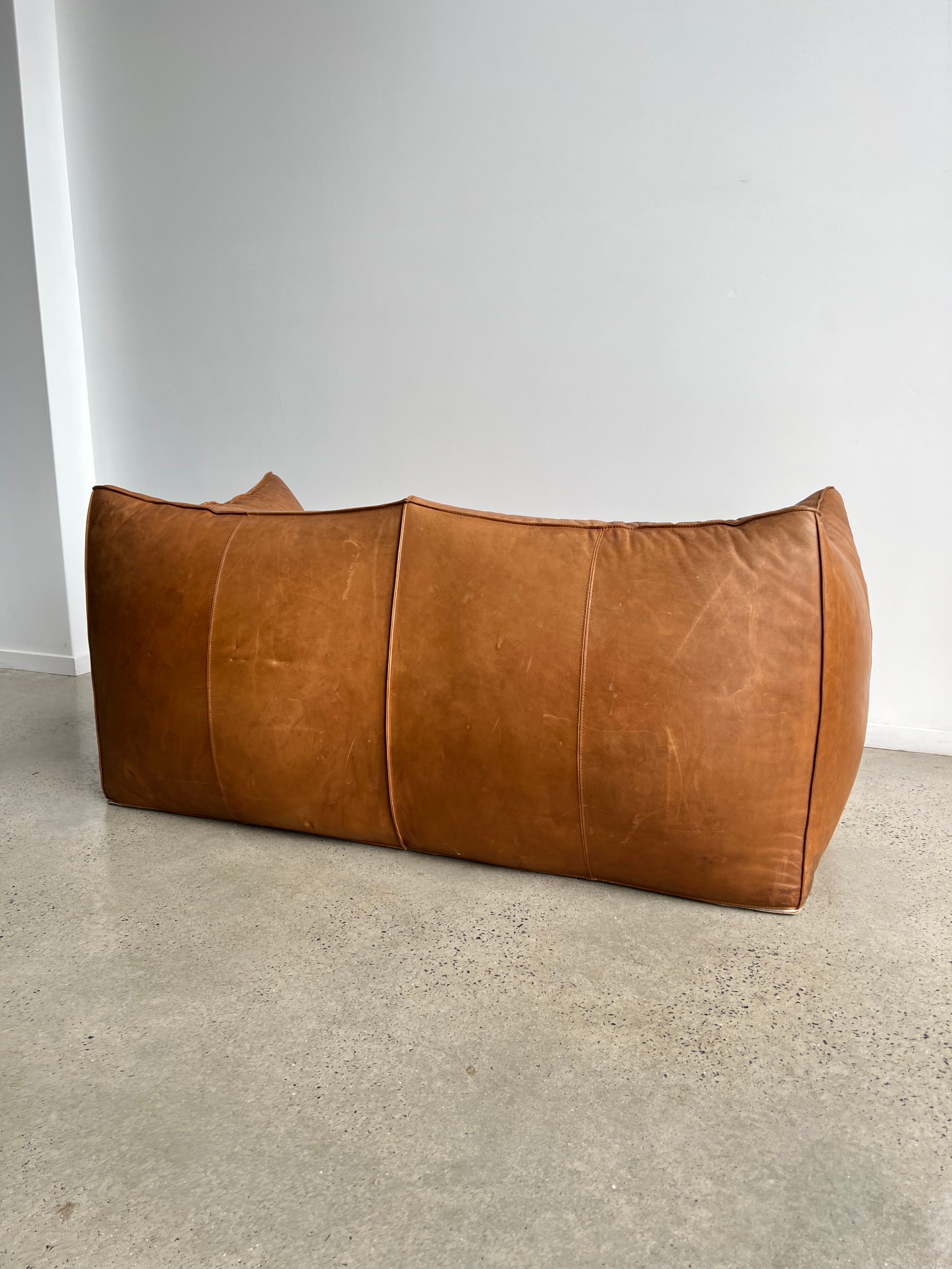brown leather sofa in a neutral space