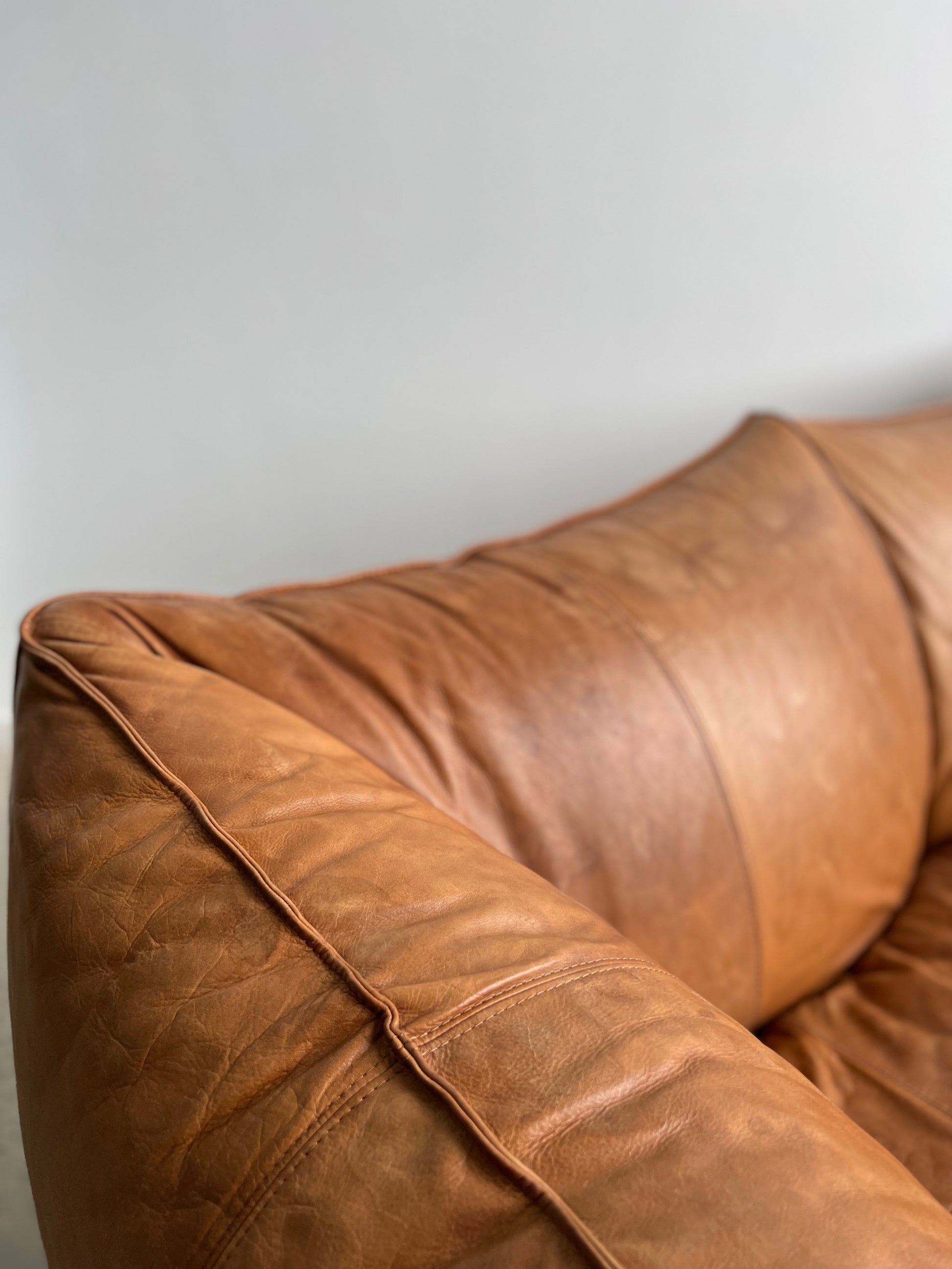 brown leather sofa in a neutral space