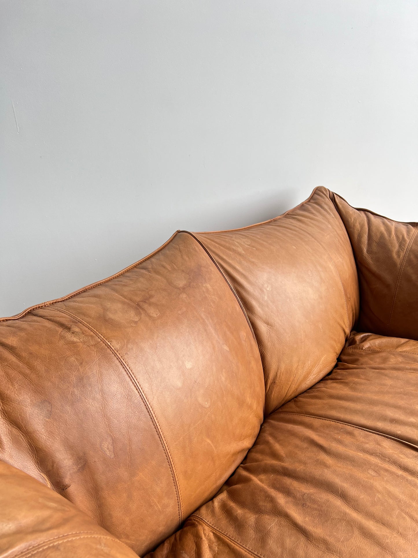 brown leather sofa in a neutral space