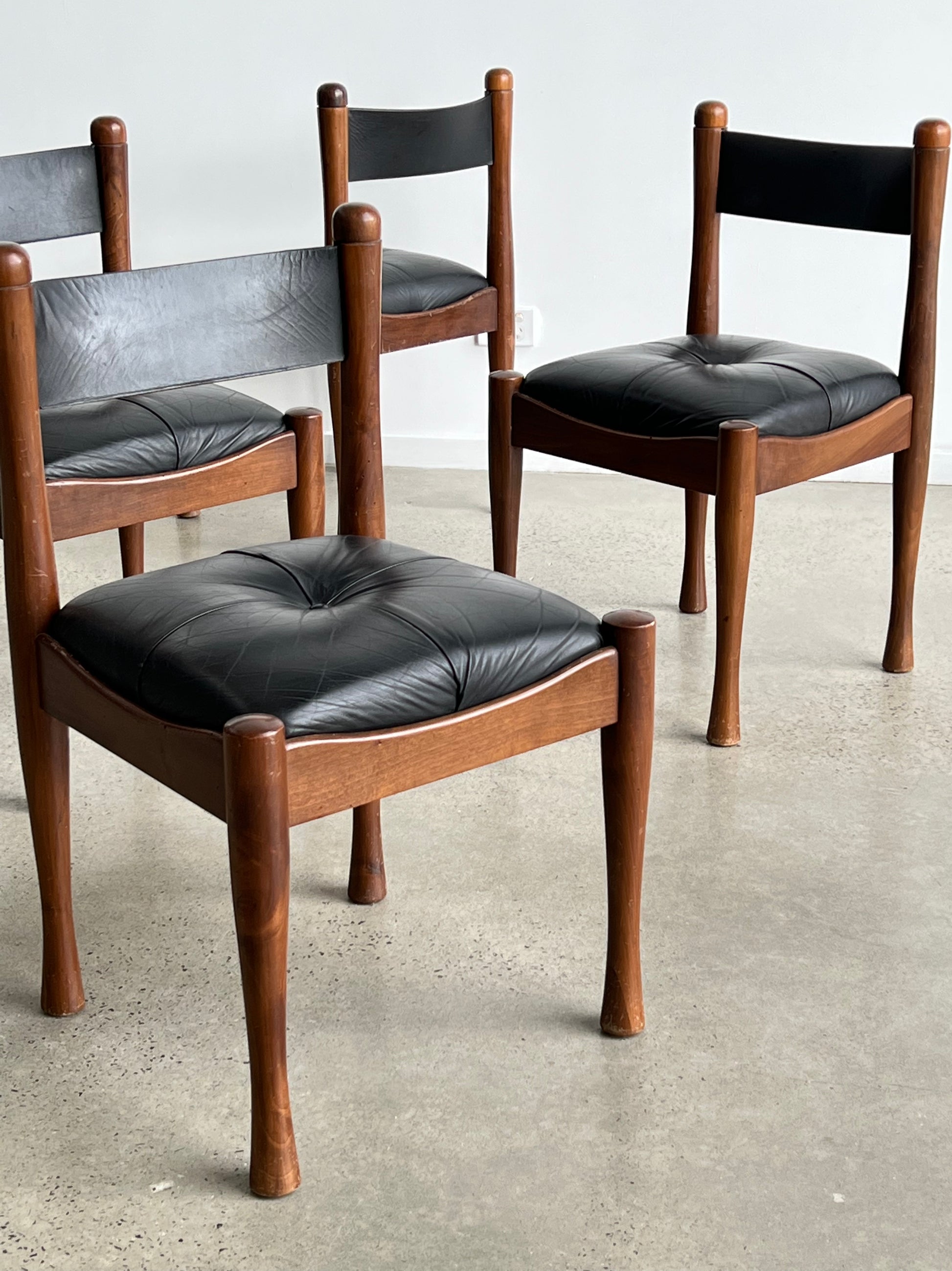 “Italian Mid Century Modern dining chair design by Silvio Coppola with leather seat”
